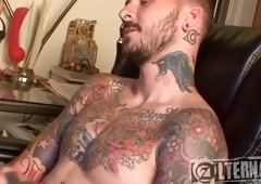 Sexual homo guy with a sexy tattooed body playing with his big cock